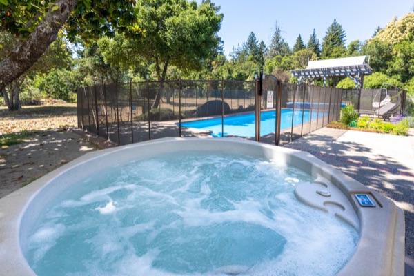 Hot tub with pool & garden view